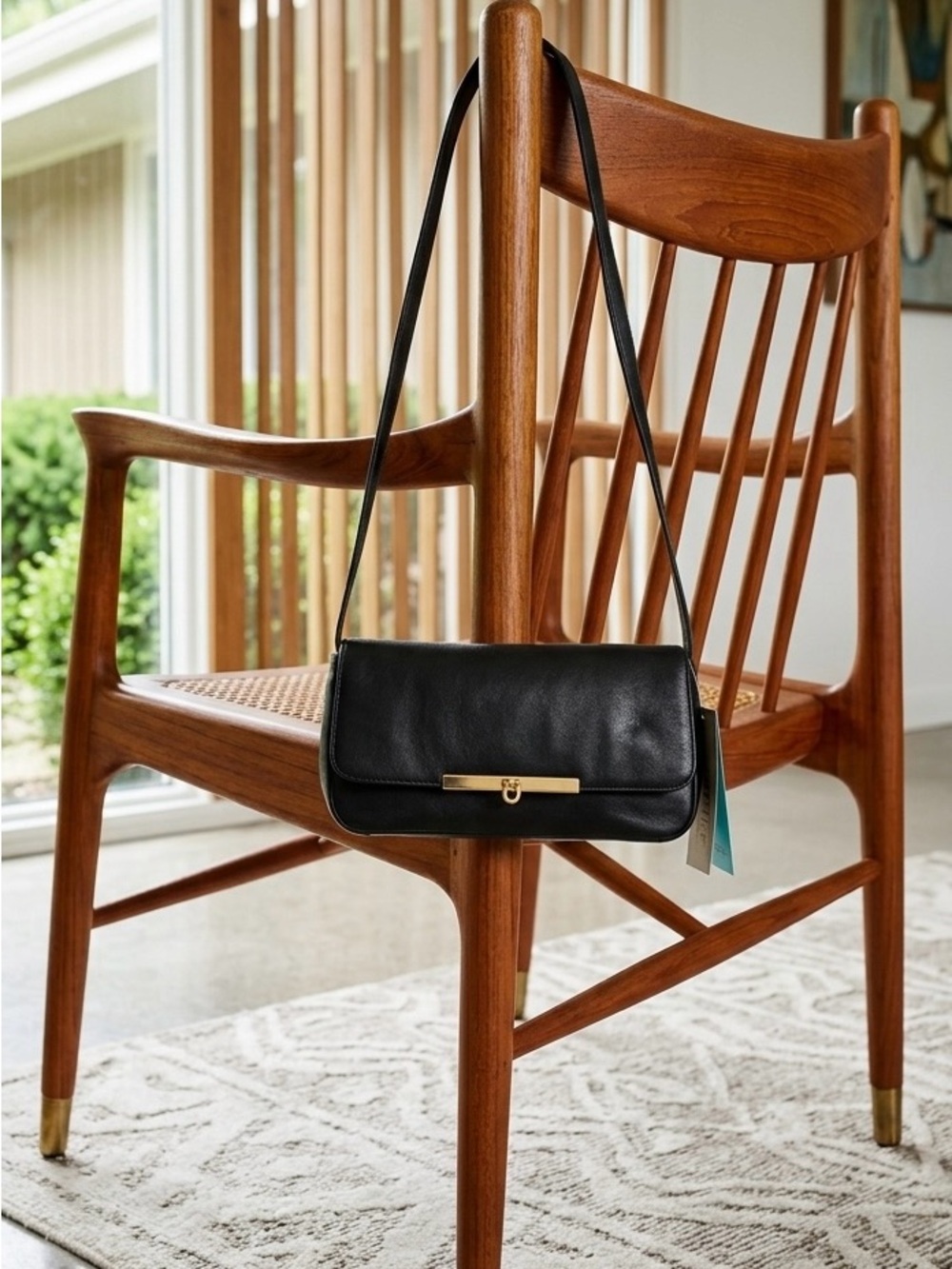 Minimalist Black Shoulder Bag with Gold Bar Detail fold over clasp detail